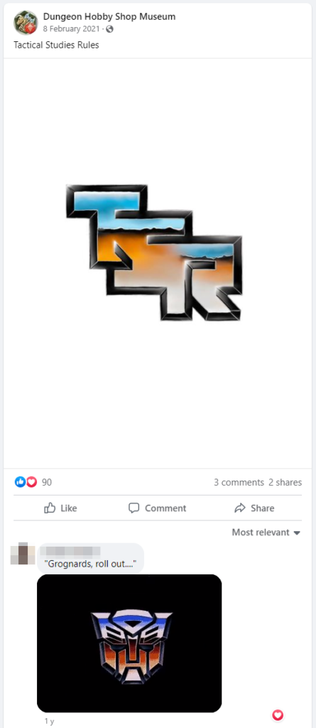 A screenshot of the Facebook post with "Tactical Studies Rules" and the coloured in version of the TSR angled down logo.
The top comment is "Grognards, roll out..." with a gif of the Autobots/Decepticons transition.