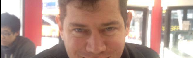 A photo of me in a black turtleneck in a cafe.