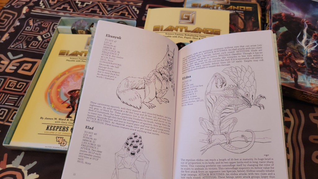 A photo of the box with two of the booklets in the background, and one open to show the contents of the monster folio type book.  Text seems very cramped, and the priority seems to have been to get at least one illustration per creature in the book.