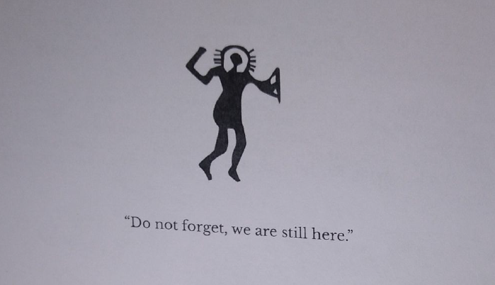 A zoom in photo of the "Do not forget, we are still here." statement.