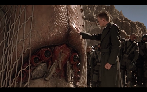 The screencap of the SS stand in character from Starship Troopers putting his hand on the captured "Brain Bug" to determine it's afraid.