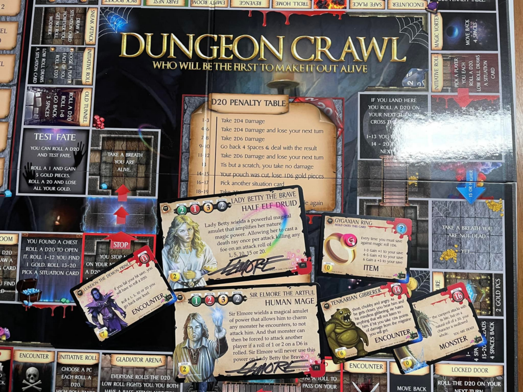 A photo of the laid out Dungeon Crawl game with the signed Elmore cards on display, along with the Lukeion the Demon Prince and Tenkarian Gibberer cards.