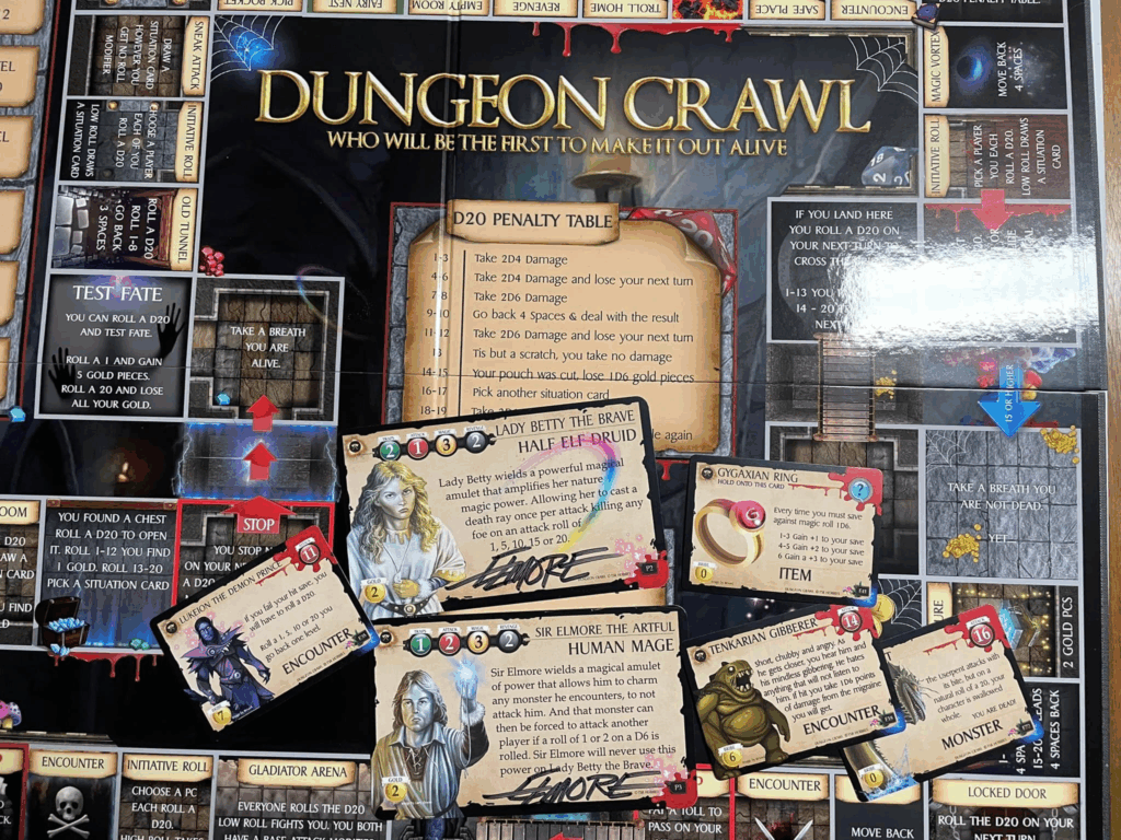 A photo of the laid out Dungeon Crawl game with the signed Elmore cards on display, along with the Lukeion the Demon Prince and Tenkarian Gibberer cards.